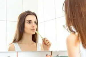 young woman brushing teeth